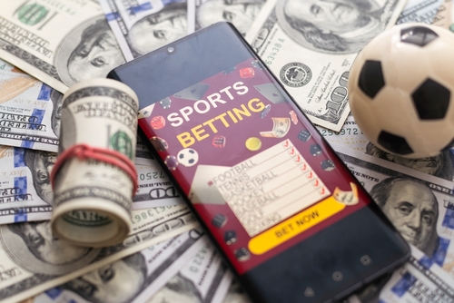 Inscription your bet wins on a smartphone on the poker table. Bets, sports betting, bookmaker. Mixed media.